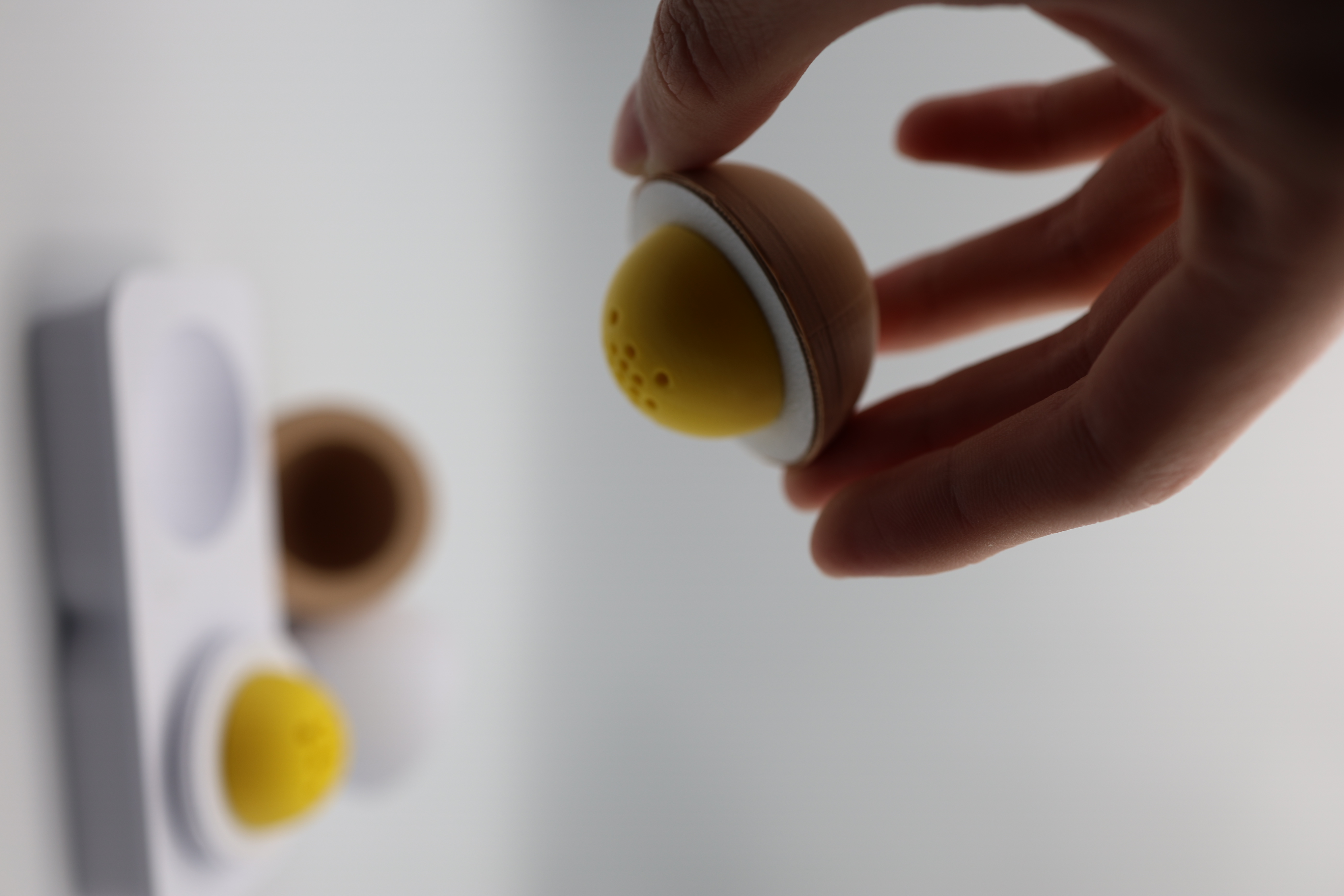 A hand interacting with one of the product forms